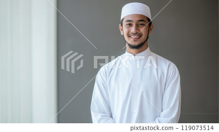 Portrait of a Young Malaysian Sunni Muslim Cleric, Traditional White Attire with a Peaceful Background, Ideal for Religious and Cultural Publications 119073514