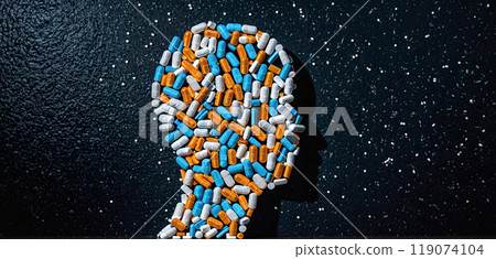 conceptual visualization of a human head surrounded by drugs or consisting of tablets and capsules to show an ever-increasing drug consumption that can lead to health problems or addictions 119074104
