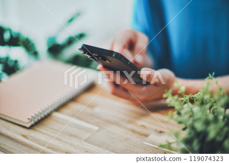 Hands of a woman operating a smartphone Hands of a woman operating a smartphone 119074323