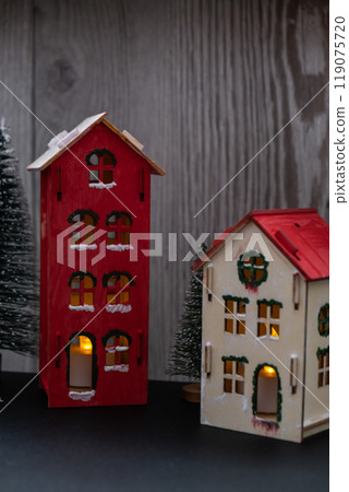 Sustainableminded Christmas cozy atmospheric festive decor in modern scandinavian home handmade decoration. Craft wooden houses. Seasonal activity for kids. Christmas Sustainableminded Christmas cozy atmospheric festive decor in modern scandinavian home handmade decoration. Craft wooden houses. Seasonal activity for kids. Christmas 119075720