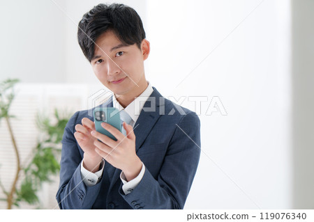 Man in suit, smartphone Man in suit, smartphone 119076340