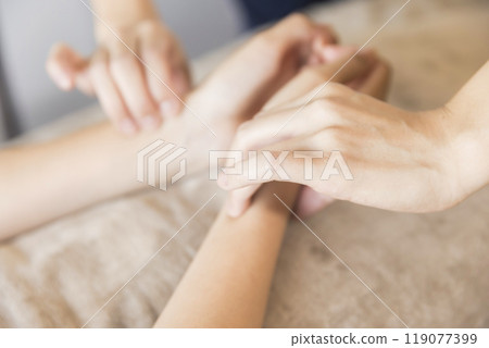 Acupuncturist taking a pulse Acupuncturist taking a pulse 119077399