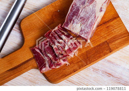 Sliced lacon curado on wooden background 119078811
