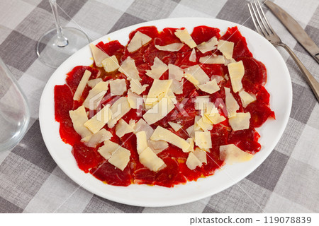 Plate of delicate raw veal carpaccio with cheese Plate of delicate raw veal carpaccio with cheese 119078839