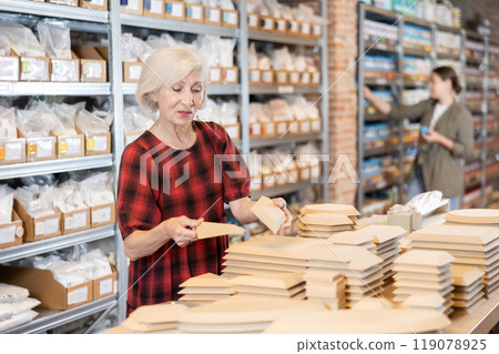 Buying wooden molds for clay products in pottery shop Buying wooden molds for clay products in pottery shop 119078925