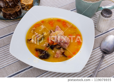 Hot pea soup with smoked meats and vegetables 119078935