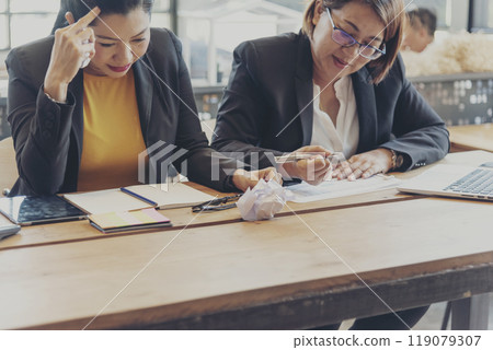 Asian businesswoman overworked at office stressful anxiety with serious problems. Woman exhaustion depress and mental burnout feeling tired frustrate at company office. Stress sadness contemplation 119079307