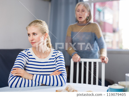 Elderly mother is unhappy with her adult daughter during domestic quarrel Elderly mother is unhappy with her adult daughter during domestic quarrel 119079405