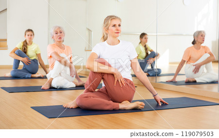 Woman doing stretching workout Woman doing stretching workout 119079503