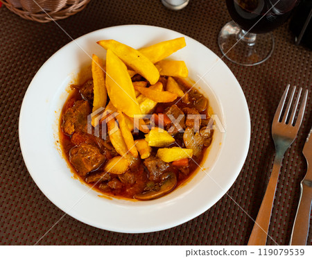 Braised veal with baked potato and mushrooms Braised veal with baked potato and mushrooms 119079539
