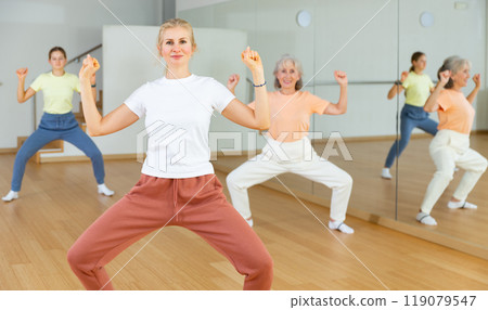 Woman squatting with family during fitness training 119079547
