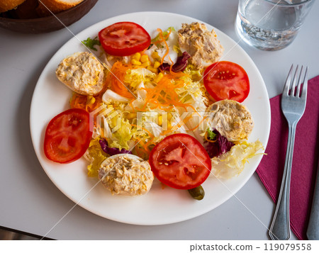 Vegetable salad with stuffed egg halves Vegetable salad with stuffed egg halves 119079558