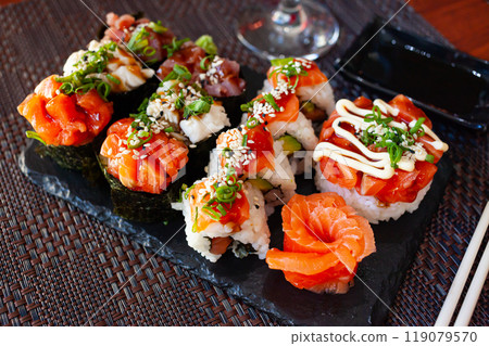 Combined sushi - gunkan, uramaki, sashimi closeup. Japanese cuisine Combined sushi - gunkan, uramaki, sashimi closeup. Japanese cuisine 119079570