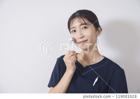 A female acupuncturist using a microneedle facial roller A female acupuncturist using a microneedle facial roller 119081028
