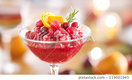 Refreshing cranberry cocktail garnished with orange slices and rosemary, perfect for festive occasions. 119081943