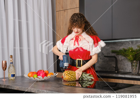 Funny woman cutting pineapple with jigsaw 119081955