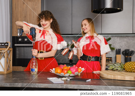 Smiling woman opens a bottle of champagne with a screwdriver Smiling woman opens a bottle of champagne with a screwdriver 119081965