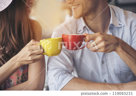 Young couple talking in cafe coffee shop happy date couple communication positive relationship while relaxing in cafe drinking coffee and talkative. Valentine's day concept. Young couple talking in cafe coffee shop happy date couple communication positive relationship while relaxing in cafe drinking coffee and talkative. Valentine's day concept. 119083231