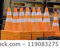 Vermilion traffic cones with white lines lined up and stacked 119083275