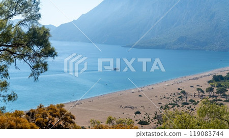 Cirali beach in Antalya, Turkey, features the Mediterranean's beauty with clear blue sea, lush green forests, and majestic mountains, a top spot for tourists. Cirali beach in Antalya, Turkey, features the Mediterranean's beauty with clear blue sea, lush green forests, and majestic mountains, a top spot for tourists. 119083744