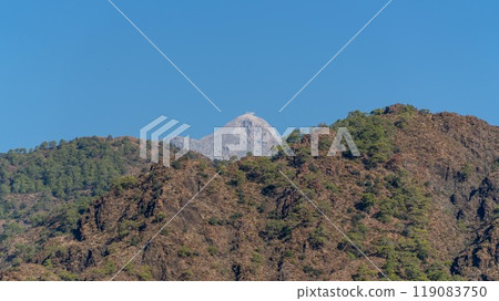 Tahtali Olympos mountain peak as seen from the Lycian Way in Cirali, Antalya, Turkey. The scenic landscape features lush forests, blue skies, and rugged slopes. Tahtali Olympos mountain peak as seen from the Lycian Way in Cirali, Antalya, Turkey. The scenic landscape features lush forests, blue skies, and rugged slopes. 119083750