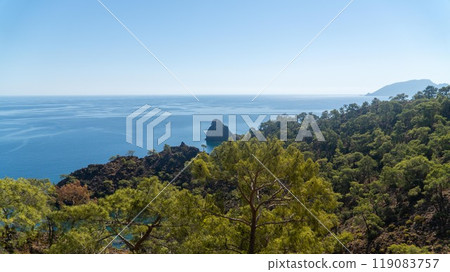 The stunning Turkish Mediterranean coastline as seen from the Lycian Way in Antalya features a blue sea, lush green forests, and rugged rocky shores, attracting tourists every summer. 119083757