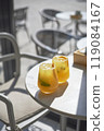 Sunny orange iced drinks in a cafe 119084167
