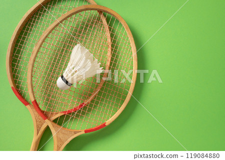 White badminton shuttlecock and two badminton rackets. Concept racket sport. 119084880