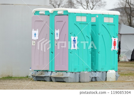 A portable toilet placed outdoors 119085304
