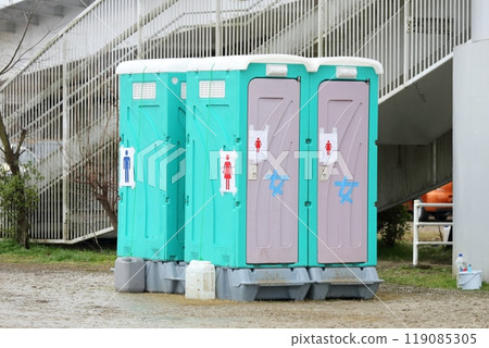 A portable toilet placed outdoors 119085305
