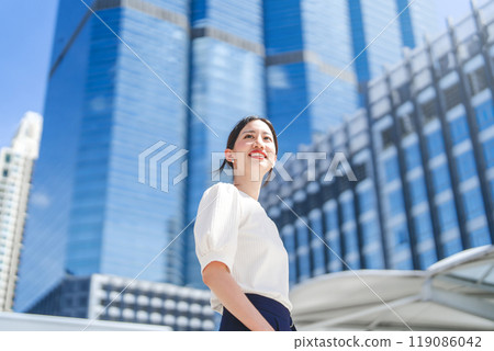 Portrait of successful business asian woman standing looking forward at outdoors in city 119086042