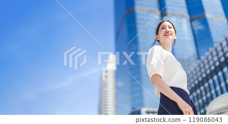 Portrait of successful business asian woman standing looking forward at outdoors in city 119086043