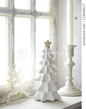 Christmas tree on an antique windowsill 119086677