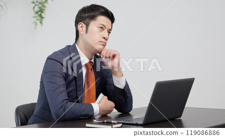A businessman worried in front of a computer 119086886