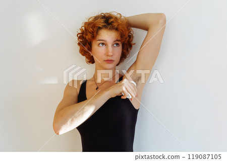 young woman uses hygiene product, roll-on deodorant 119087105