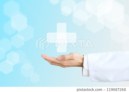 A doctor's hand holding a cross symbolizing medical care 119087268