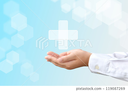 A child's hands holding a cross symbolizing medical care 119087269