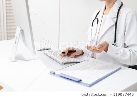 A female doctor in a white coat 119087446