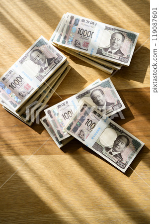 A stack of bills on a table (new bill version) 119087601