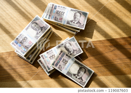 A stack of bills on a table (new bill version) 119087603