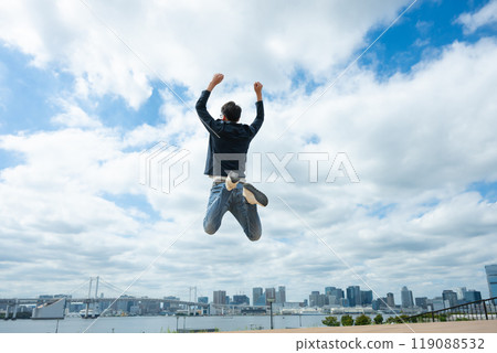 Man jumping into the blue sky Man jumping into the blue sky 119088532