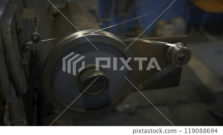 Industrial Rotating Machine with wire. Creative. Rotating coils winding wire at factory. Industrial workshop with wire on rotating machines of metallurgical production Industrial Rotating Machine with wire. Creative. Rotating coils winding wire at factory. Industrial workshop with wire on rotating machines of metallurgical production 119088694