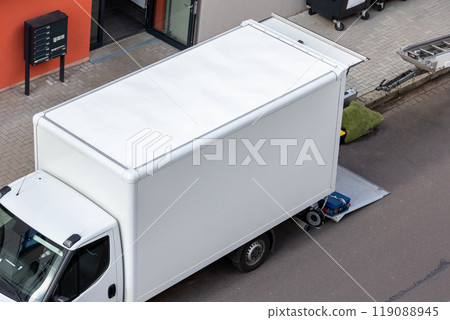 Mover service lifting ladder cargo crane platform vehicle van parked at city street. Retractable furniture elevator machine car pickup truck rental company for relocation and house moving delivery Mover service lifting ladder cargo crane platform vehicle van parked at city street. Retractable furniture elevator machine car pickup truck rental company for relocation and house moving delivery 119088945