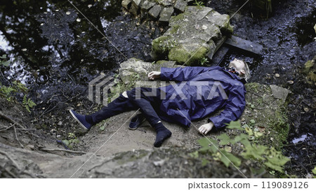 Corpse of young man in forest. Stock. Young man died as result of fall from cliff in forest. Stone cliff with corpse at bottom of water Corpse of young man in forest. Stock. Young man died as result of fall from cliff in forest. Stone cliff with corpse at bottom of water 119089126