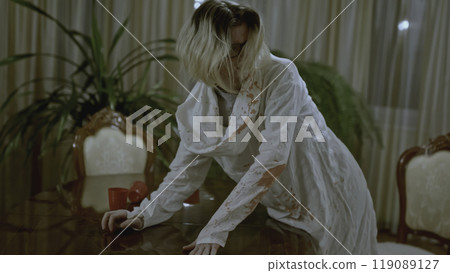 Man is covered in blood after murder. Stock. Young man is covered in blood after murder in apartment. Man stained with blood is in shock after murder 119089127