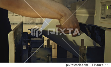 Man inserts paper into printer. Stock footage. Man puts paper in printer for industrial printing. Paper for printing industrial drawings Man inserts paper into printer. Stock footage. Man puts paper in printer for industrial printing. Paper for printing industrial drawings 119089136