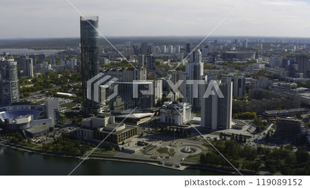 Top view of beautiful city with high-rise buildings in summer. Stock footage. Landscape of modern city from bird's-eye view. Beautiful sunny day in modern city with skyscrapers and river in summer 119089152