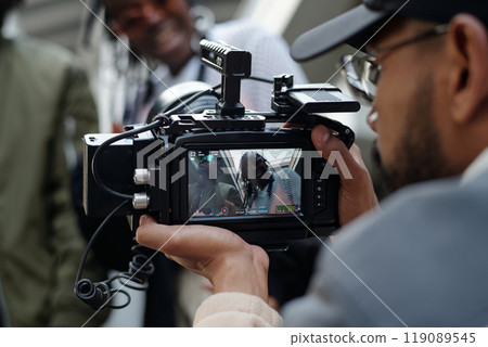 Filming a Person Talking Through Professional Camera 119089545