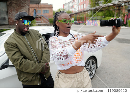 Taking Selfie Outdoors with Urban Background 119089620