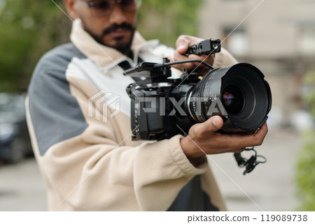 Operating Professional Camera during Outdoor Shoot 119089738